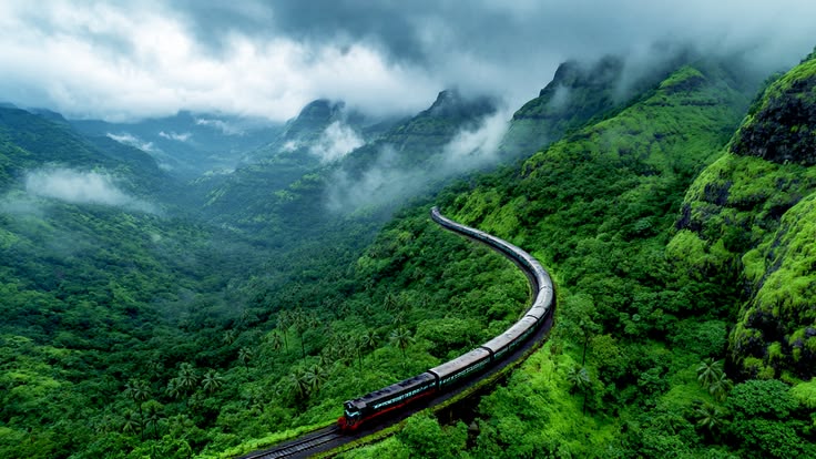 Kokan Railway train winding through misty green Sahyadri mountains