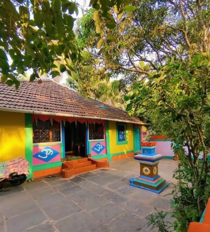 Colourful Kokan Home surrounded by the landscape and homes of rural Kokan